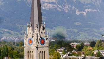 View of St. Florin's Cathedral in Vaduz with mountains in the background