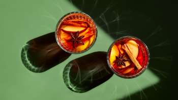 Glasses filled with mulled wine on a green table