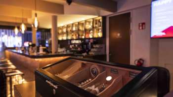 cozy bar in the Casino Admiral Triesen with elegant lighting and a large selection of drinks.
