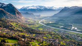 Panoramic view over the Rhine Valley Sweeping views from the hillside over the Rhine Valley with fields, villages and snow-capped mountains - a natural idyll in Liechtenstein