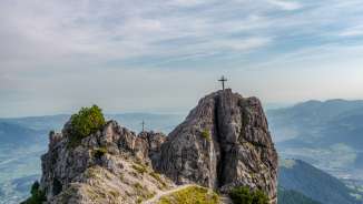 Two summit crosses on the rocks of the Drei Schwestern mountain chain with views over the Rhine Valley along Route 66 in Liechtenstein