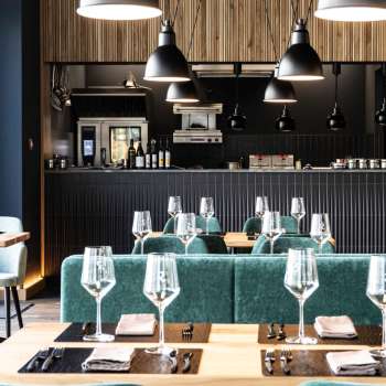 Cozy dining room with relaxed seating arrangement, modern furniture and creative wall design