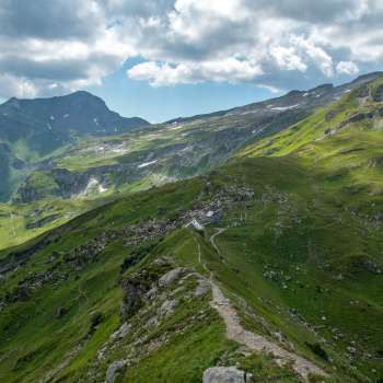 Panoramic view over the Pfälzer hut in the Liechtenstein Alps with dramatic clouds.