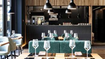 Cozy dining room with relaxed seating arrangement, modern furniture and creative wall design
