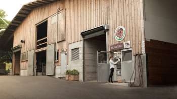Exterior view of the Kaiserhof in Liechtenstein with self-service milk filling station - regional, fresh and direct from the farm.