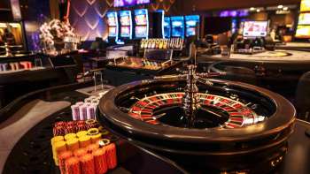 Elegant roulette table with chips and ball in the stylish interior of the Casino Admiral Triesen.
