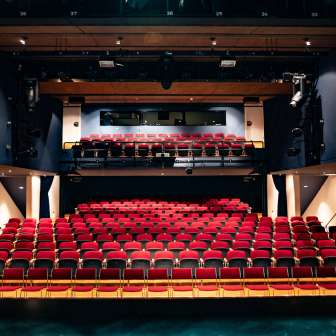 View from the stage of red rows of seats and lighting technology in the modern auditorium of the TAK Theater Liechtenstein