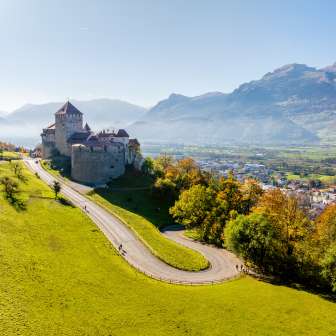 Sunny view of Vaduz Castle in Liechtenstein with surrounding landscape and Rhine Valley