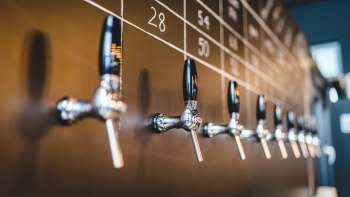 Taps with beer varieties at the bar of the Liechtenstein brewery in Vaduz