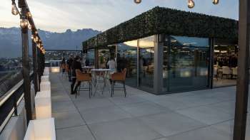 Rooftop terrace of the Casino Royal Restaurant with a view of the surrounding mountain landscape at dusk