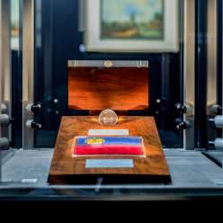 Detailed view of a presentation of the Liechtenstein national flag in a glass chamber in the SchatzKammer with a fine wooden frame