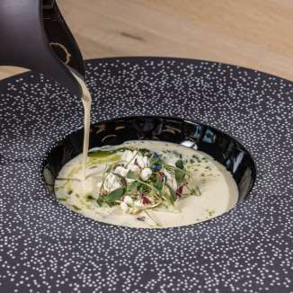 Delicious soups beautifully presented in a black plate