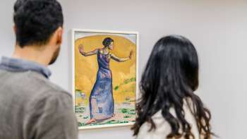 Two people look at a colorful painting in the Liechtenstein Art Museum