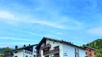 Exterior view of the restaurant from a different angle, focusing on the rustic architecture and picturesque surroundings