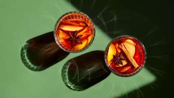 Glasses filled with mulled wine on a green table