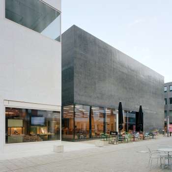 Exterior view of the Liechtenstein Art Museum with modern façade and café terrace in Vaduz.