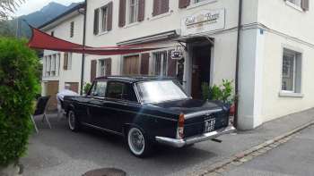 Exterior view of Eredi Fiorini Gastronomia Italiana with vintage car and inviting entrance area