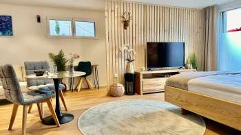 Stylishly furnished studio with king-size bed, flat-screen TV and table with two chairs