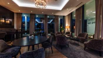  Interior of the restaurant with modern wooden tables, comfortable chairs and atmospheric lighting.