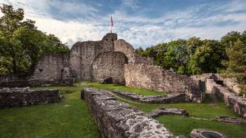 View of the medieval castle ruins of Schellenberg with a waving flag on the main tower.