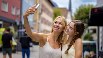 Two women take a cheerful selfie in the town of Vaduz