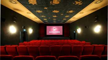 Interior of the Altes Kino Vaduz with red velvet and illuminated screen
