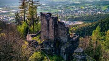 A bird's eye view of Schalun Castle, with a view over the Rhine Valley in the background
