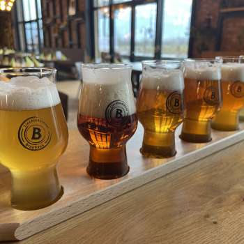 Different types of beer in a tasting set on a wooden table - from light to dark beer, served in stylish glasses in the Liechtensteiner Braustube