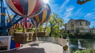 Close-up of the Liechtenstein-themed ride at Europa-Park - colorful balloons against a backdrop of half-timbered houses in the sunshine