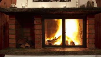 Warm fireplace with burning wood and atmospheric light