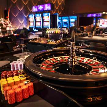Elegant roulette table with chips and ball in the stylish interior of the Casino Admiral Triesen.