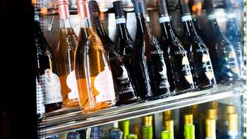 Well-stocked wine fridge with a selection of red, white and rosé wines at Dolce Gusto