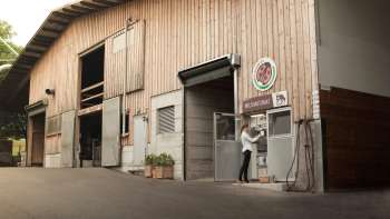 Exterior view of the Kaiserhof in Liechtenstein with self-service milk filling station - regional, fresh and direct from the farm.