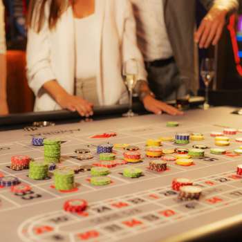 Guests at the gaming table placing their chips at Casino Admiral Triesen, surrounded by an exciting casino atmosphere.