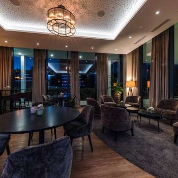  Interior of the restaurant with modern wooden tables, comfortable chairs and atmospheric lighting.