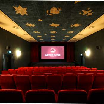Interior of the Altes Kino Vaduz with red velvet and illuminated screen