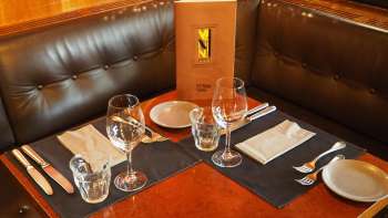 Set table with menu in the leather seating area of the Vanini Café