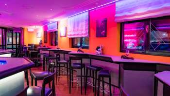 View of the interior of the Viva Bar, which is illuminated in pink