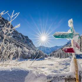 Snow-covered signposts and a fantastic winter landscape in bright sunshine in Steg, Liechtenstein.