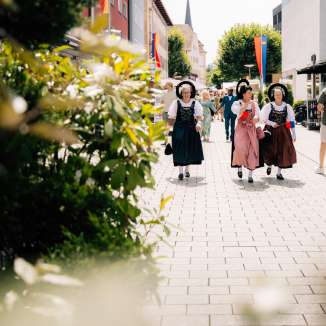 Women in traditional costumes at the 2024 national holiday in Vaduz, Liechtenstein, in sunny weather