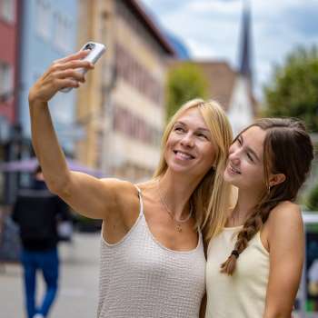 Two women take a cheerful selfie in the town of Vaduz