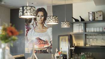 Bar area in Made in Italy with atmospheric lighting and Italian flair.
