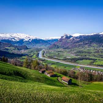 View of the Rhine Valley with the Alps, the course of the Rhine and villages - view from Liechtenstein towards Switzerland and Austria on a clear day