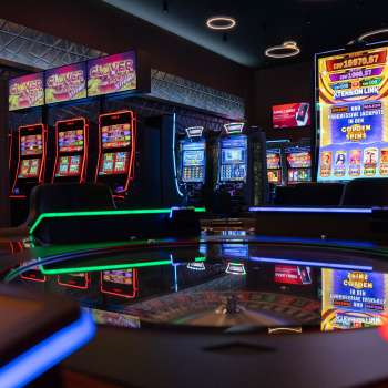 View of the modern slot machine area at Casino Admiral Triesen with colorfully illuminated slot machines.