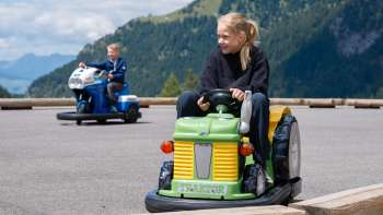 Children drive mini cars