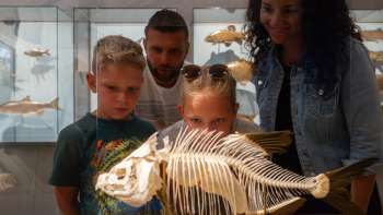 A family looks at a fish skeleton at the Liechtenstein National Museum