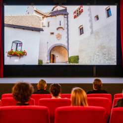 Visitors to the old cinema in Vaduz watch a movie with footage from Liechtenstein