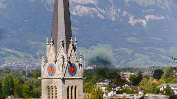 View of St. Florin's Cathedral in Vaduz with mountains in the background