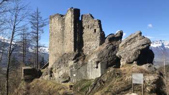The ruins of Schalun Castle nestled in a glowing autumnal forest - a romantic excursion destination above Vaduz.