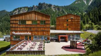 Exterior view of the JUFA Hotel Malbun, surrounded by mountains